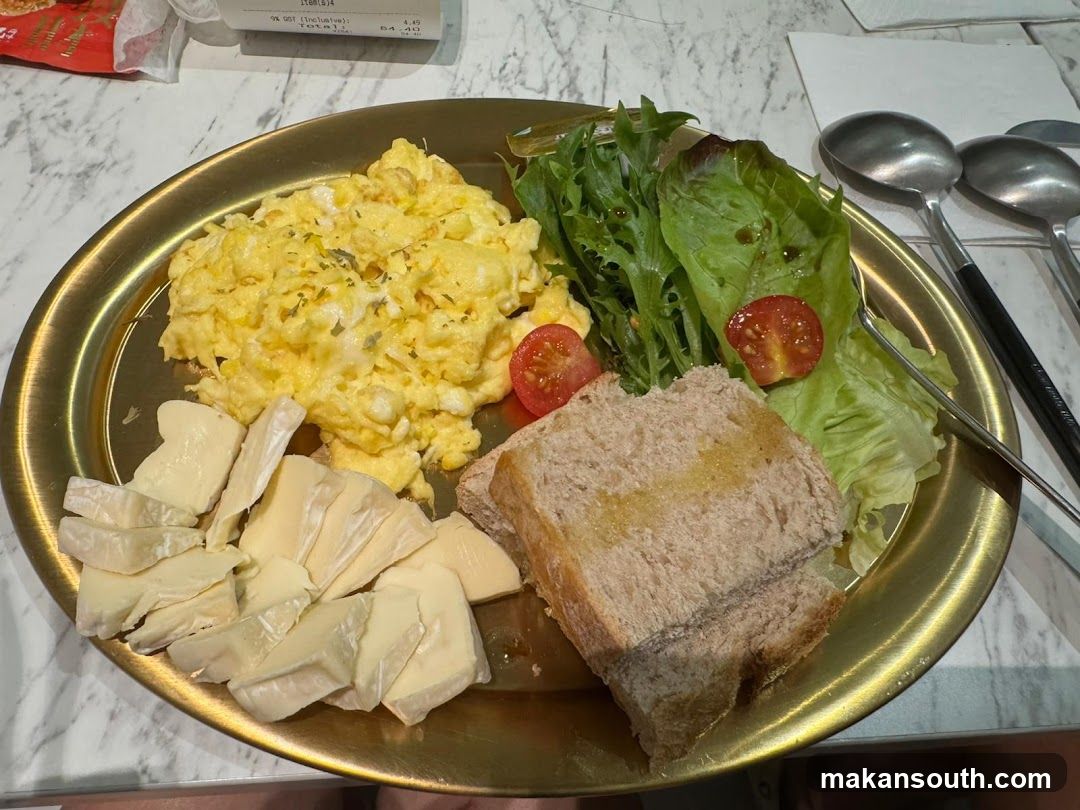 Breakfast Plate with Scrambled Eggs, Salad, and Bread
