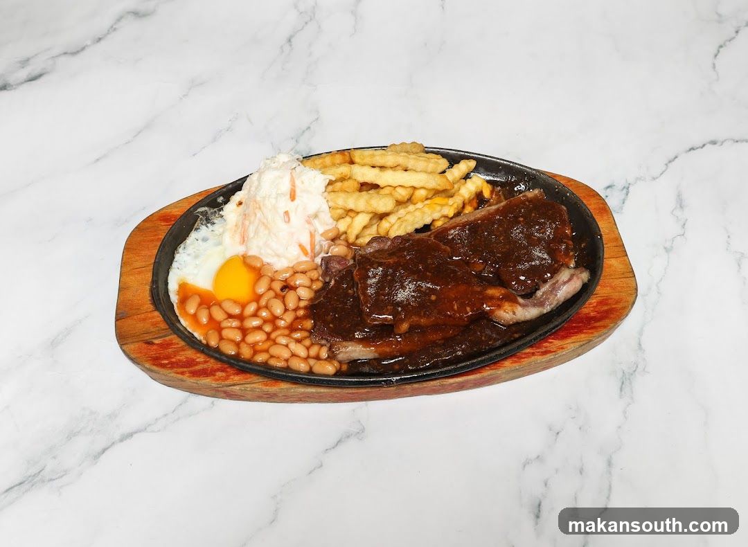 Sizzling Steak Platter with Fries, Beans and Egg