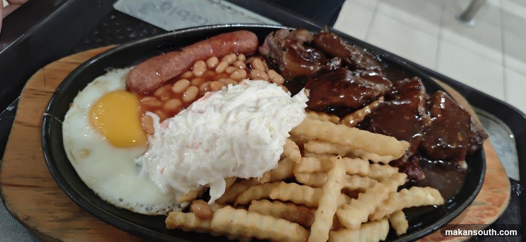 Sizzling Platter with Fried Egg, Sausage, Baked Beans, Coleslaw, Fries and Steak