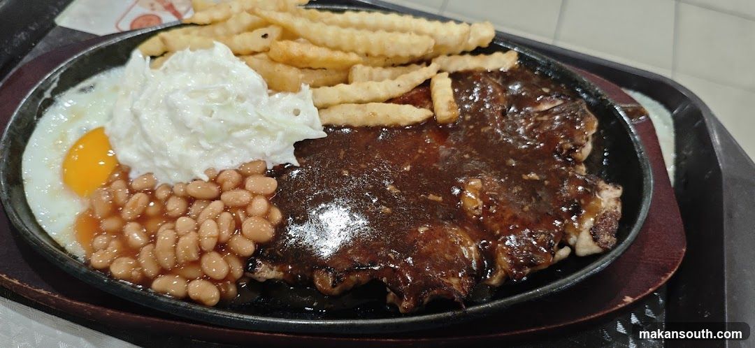 Sizzling Steak Plate with Fries, Beans and Egg
