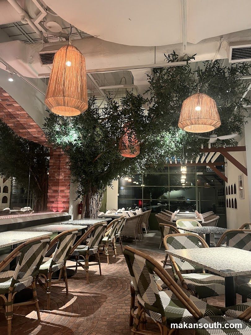 Restaurant Interior with Hanging Lamps and Greenery