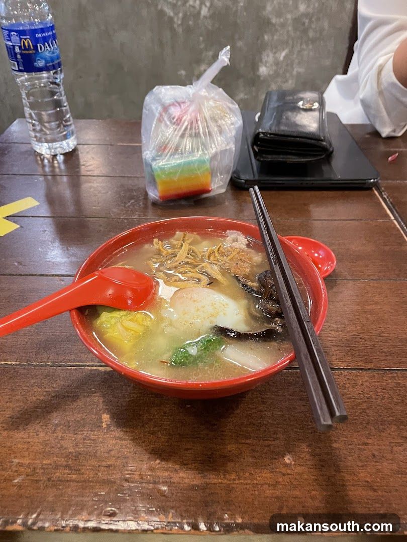 Bowl of Noodle Soup with Side Items