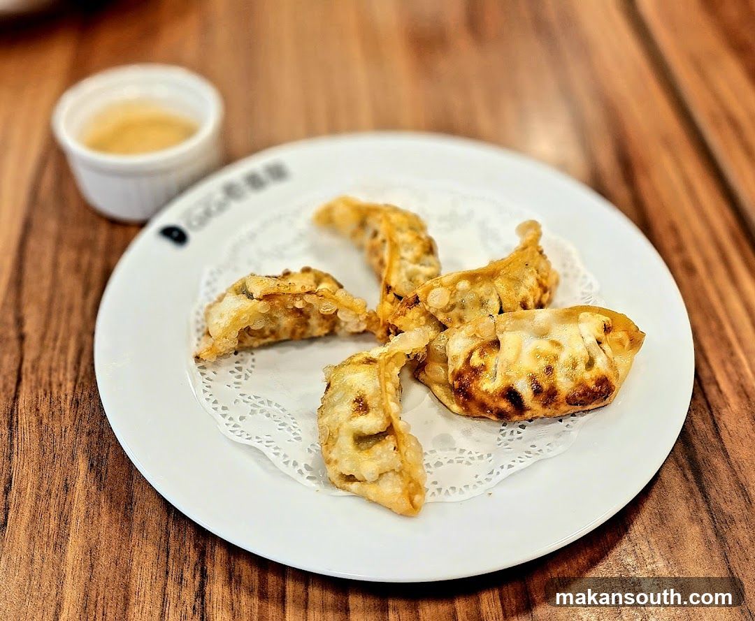 Gyoza on a plate with dipping sauce