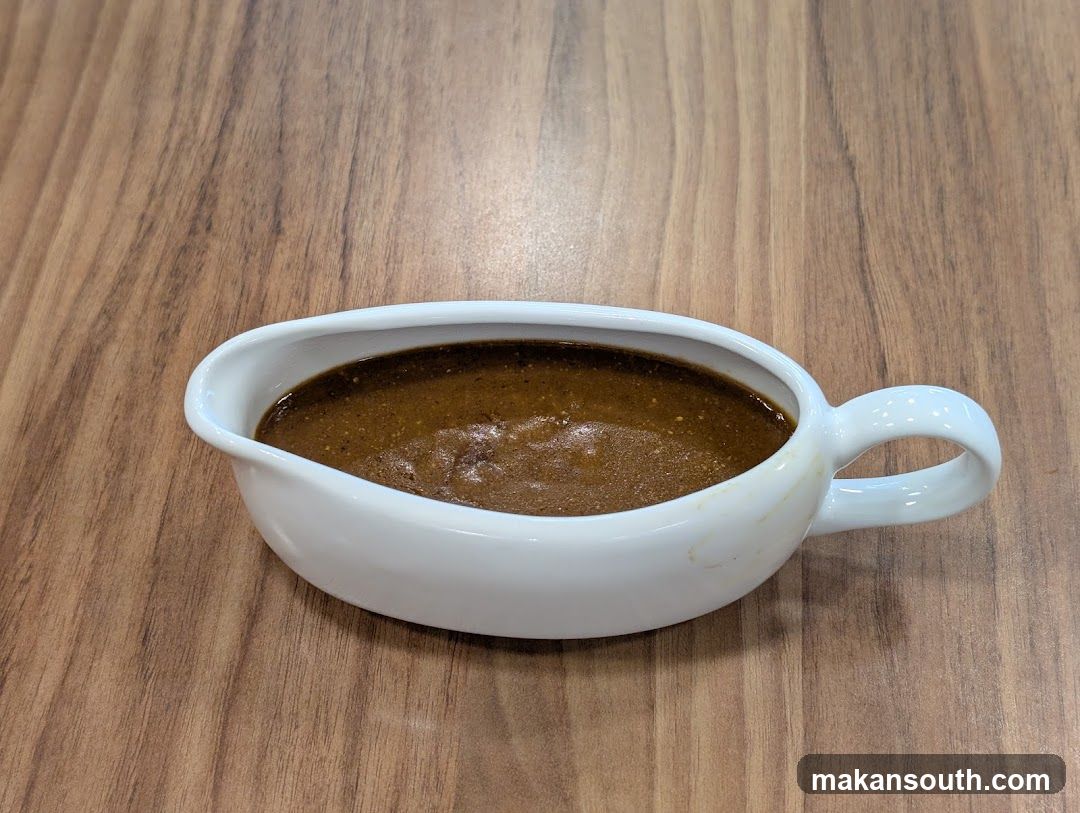 Sauce in a white gravy boat