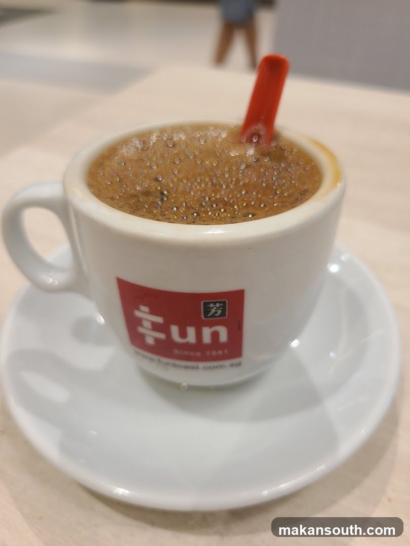 Cup of coffee with red stirrer