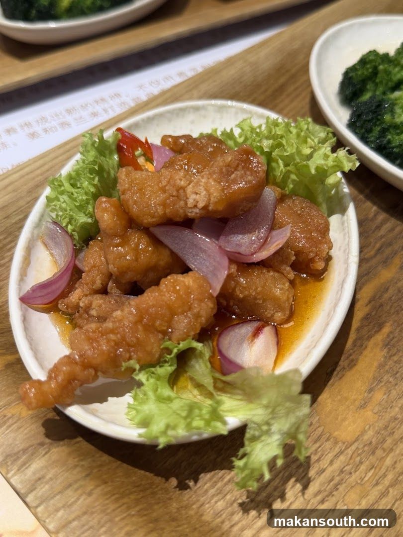 Sugared Crispy Chicken with Lettuce and Onion Garnish