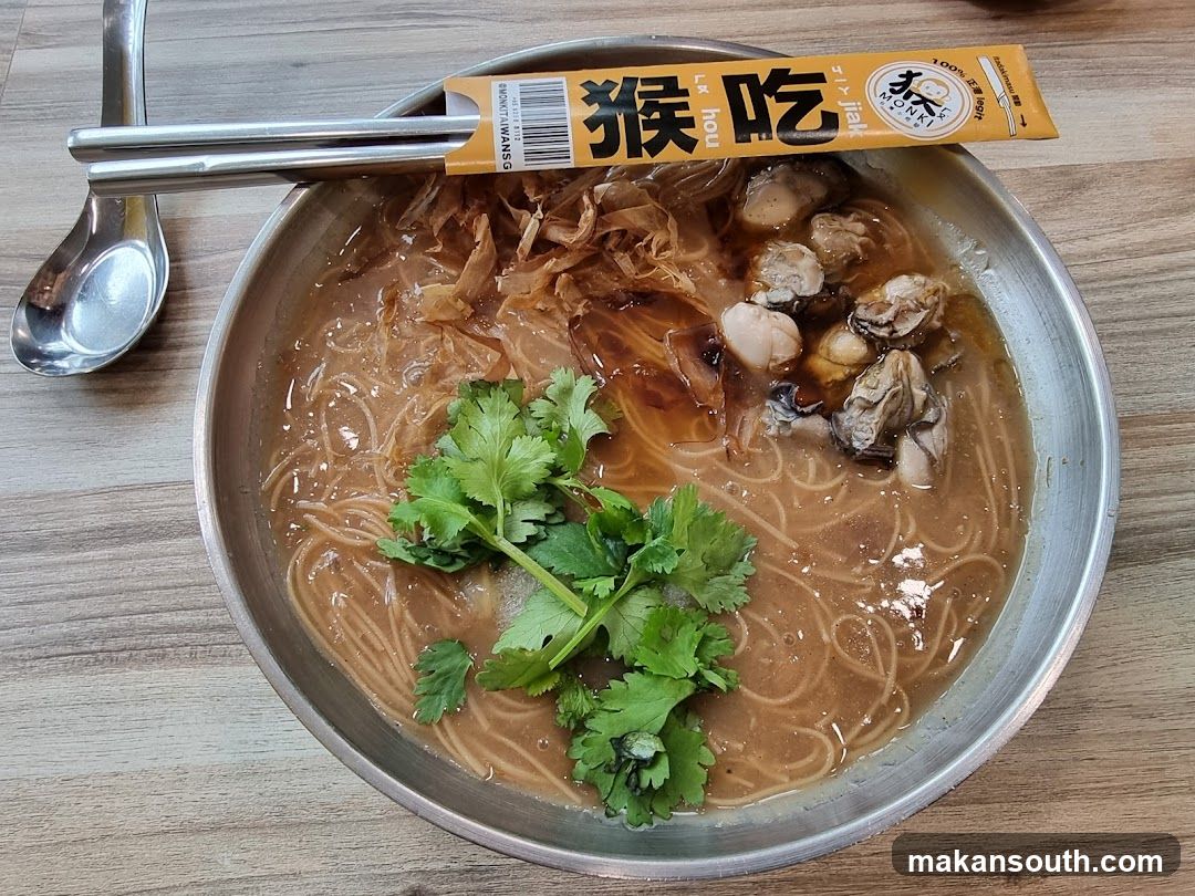 Bowl of Noodle Soup with Oysters and Cilantro