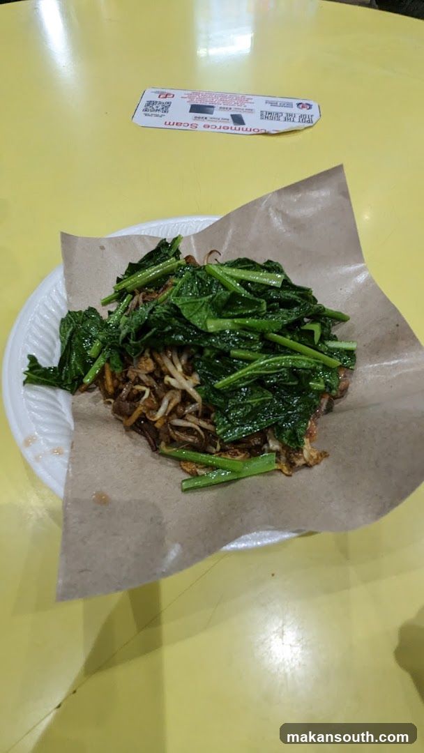 Plate of stir-fried greens and noodles