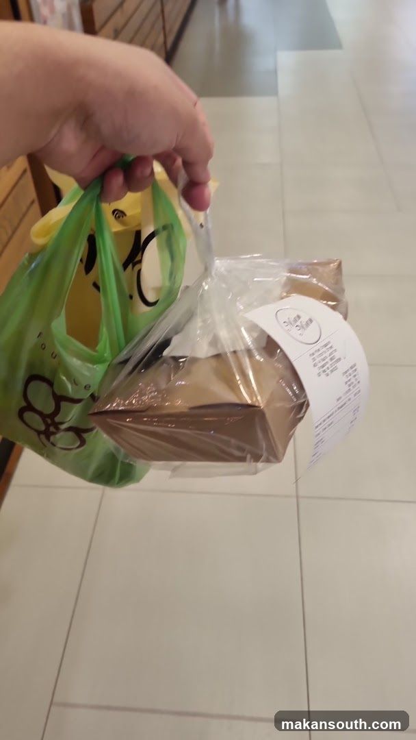 Hand holding food items in bags