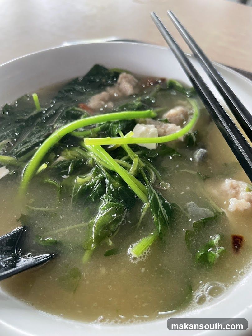 Bowl of Soup with Greens and Meatballs