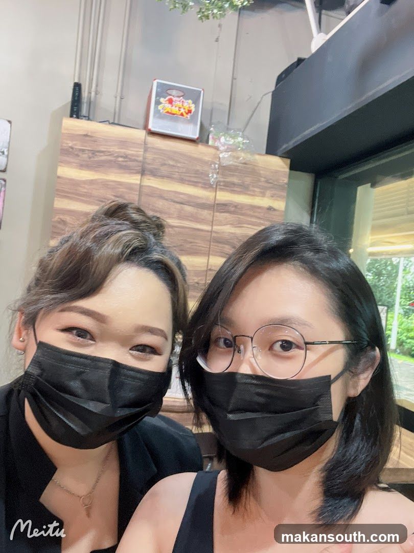 Two people wearing masks indoors