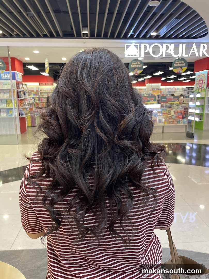 Woman with wavy hair in a bookstore