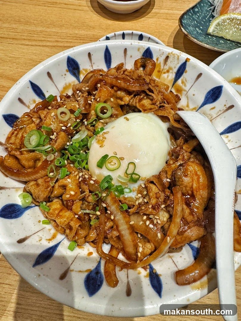 Bowl of savory noodles with egg and green onions