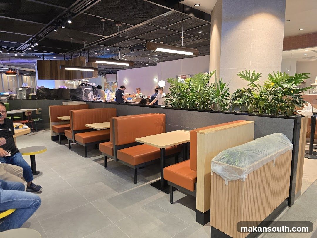 Restaurant Interior with Orange Booths and Greenery