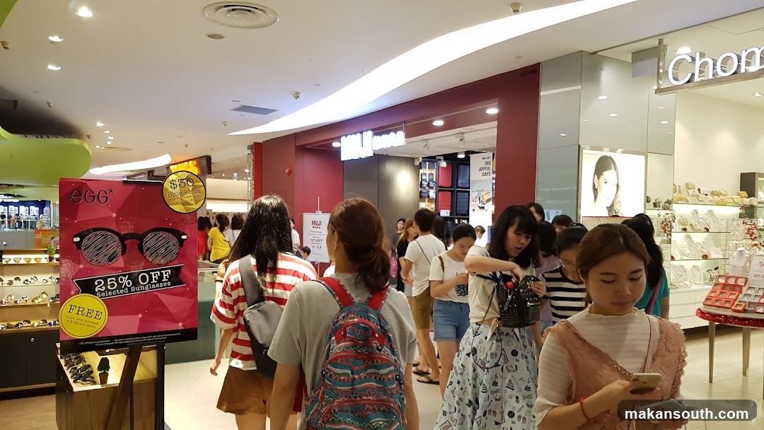 Shopping Mall Interior with Crowds and Storefronts