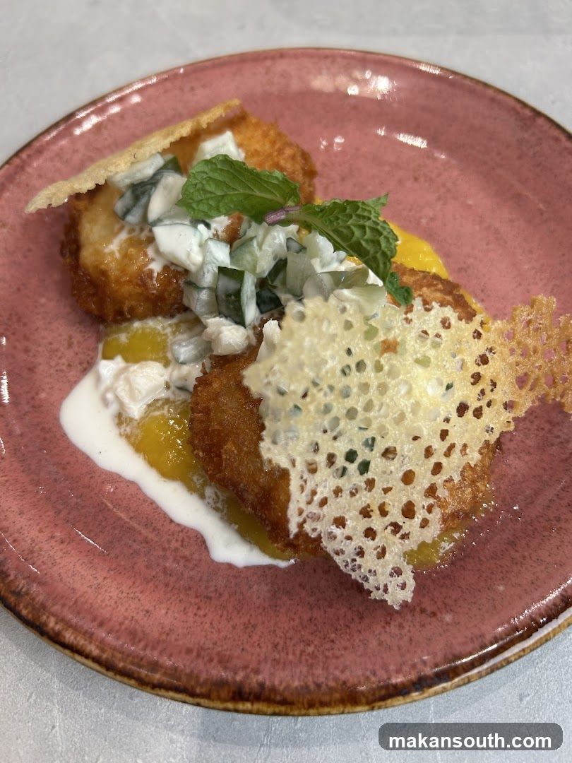 Fried Dish with Cucumber Salad and Mint Garnish