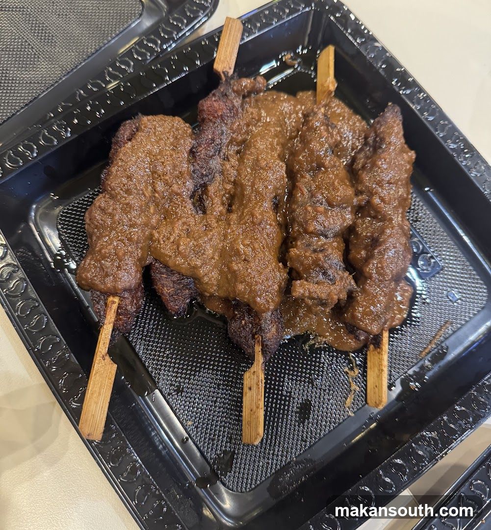 Grilled Meat Skewers in Black Container