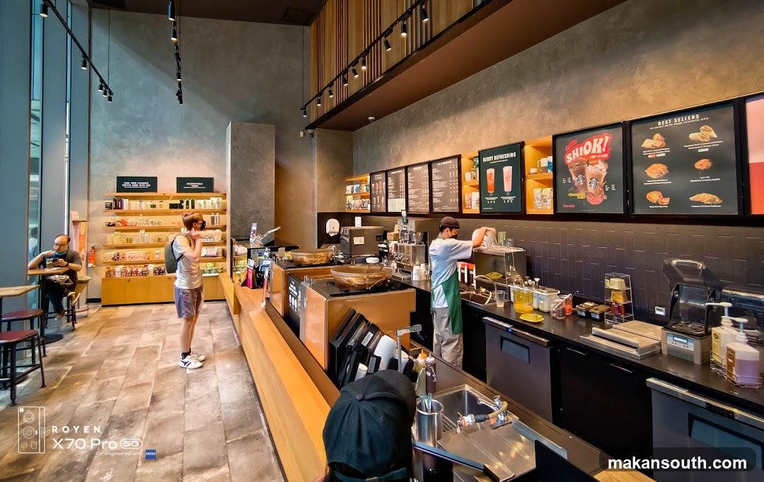 Coffee Shop Interior with Menu Boards and Staff
