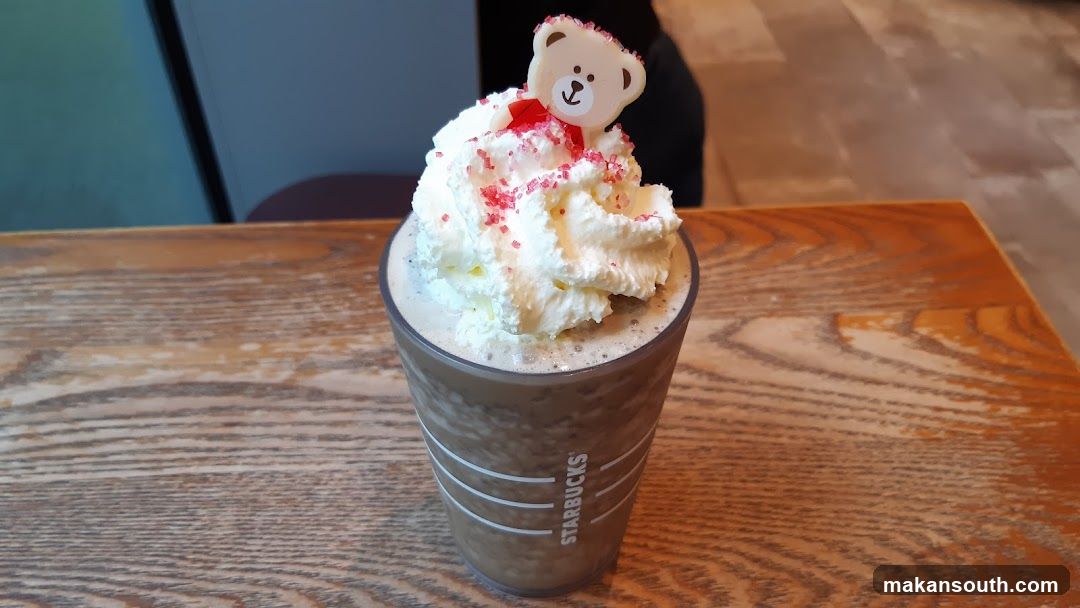 Bear-themed Starbucks drink with whipped cream and sprinkles