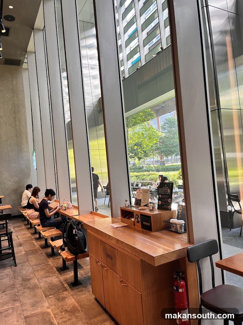 Interior of a modern café with large windows and wooden furniture