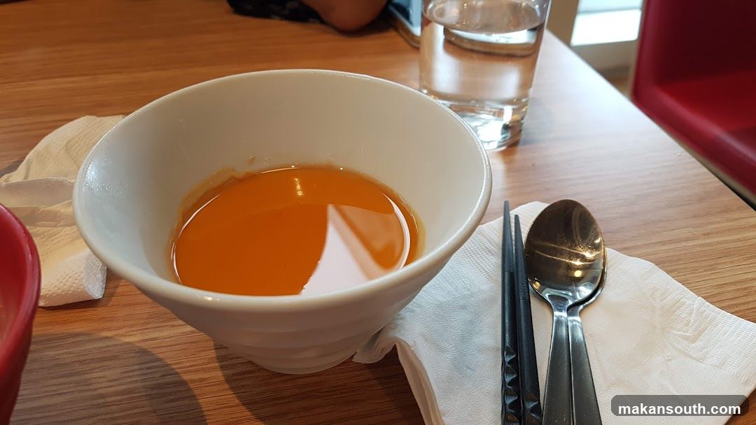 Bowl of Soup with Chopsticks and Spoon