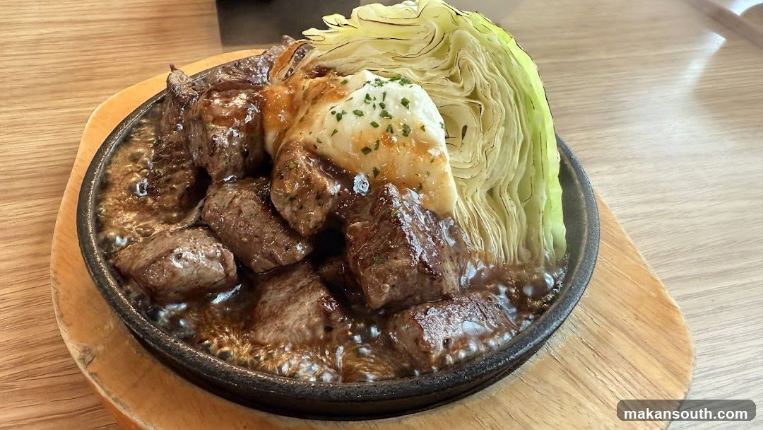 Sizzling Steak with Cabbage and Melted Cheese