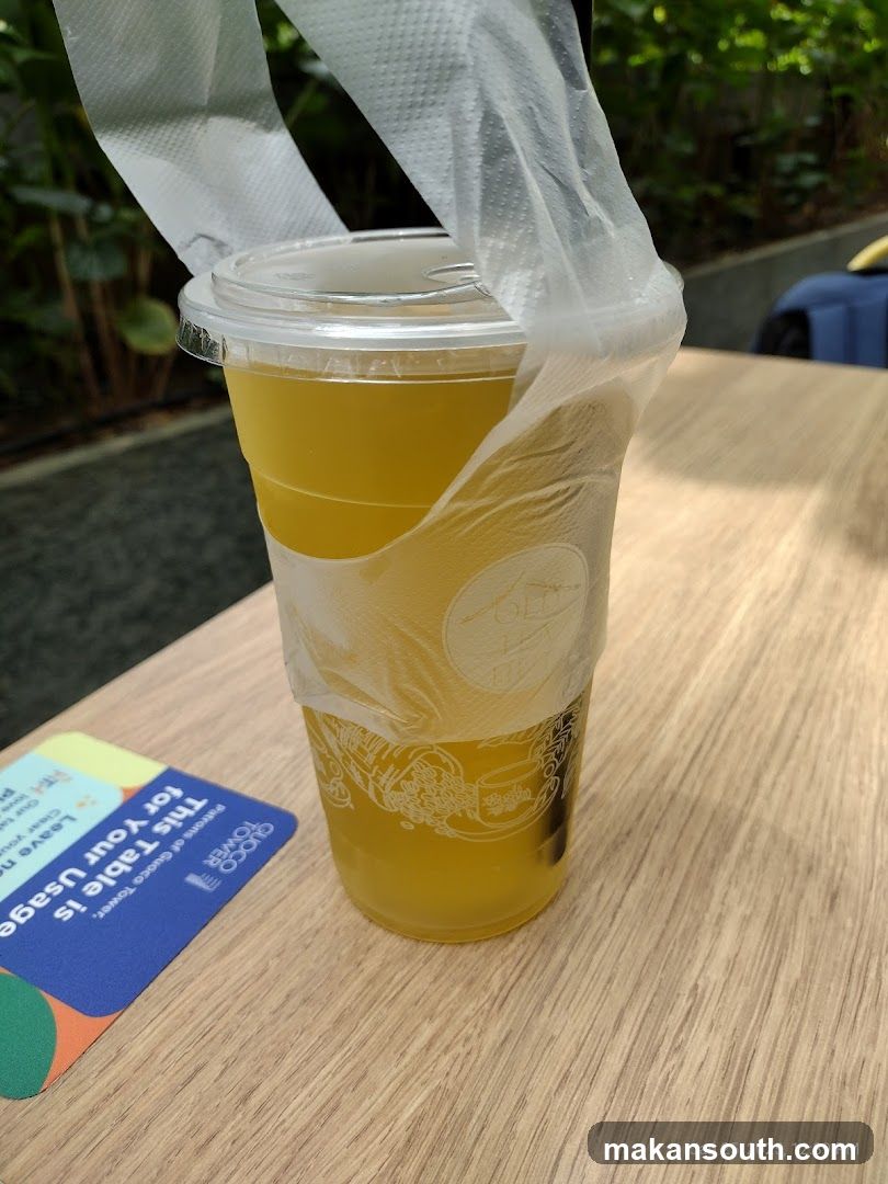 Yellow Drink in Plastic Cup