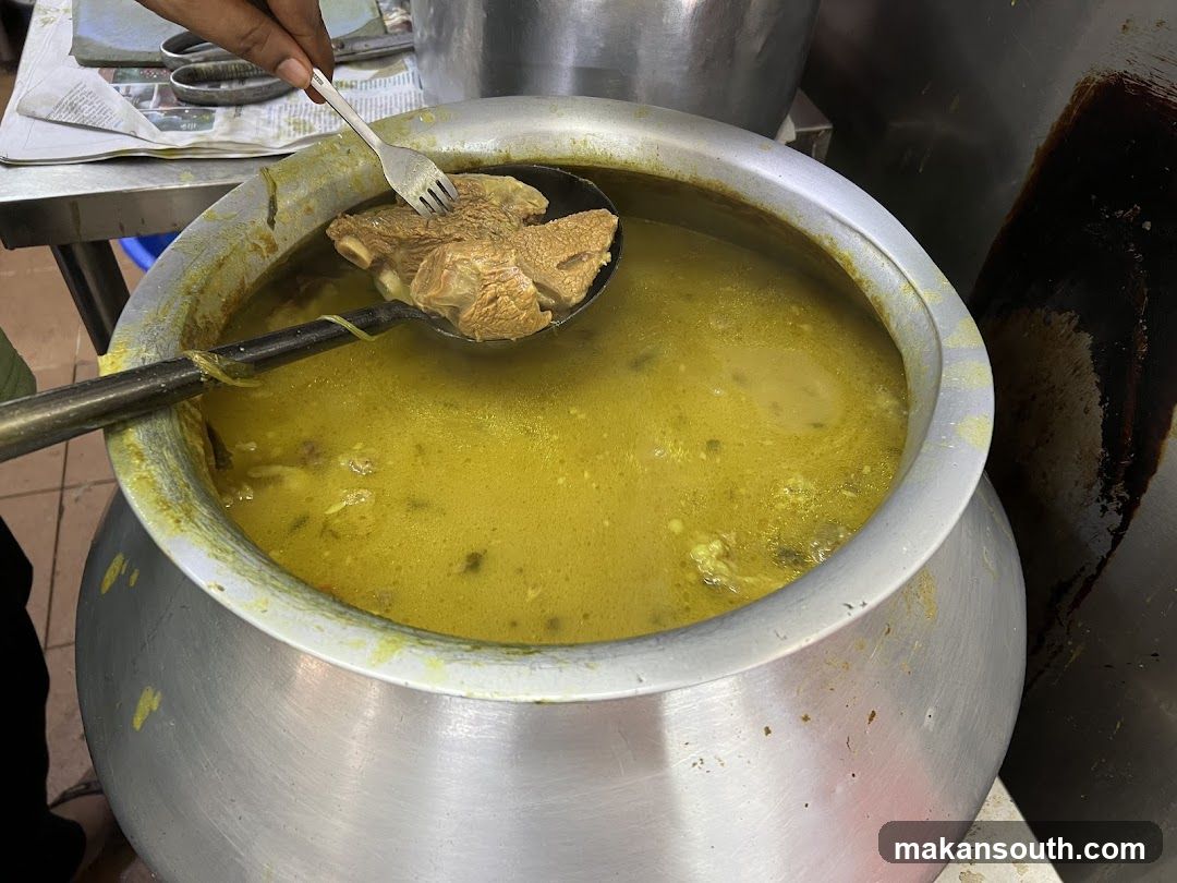 Large Pot of Yellow Soup with Meat