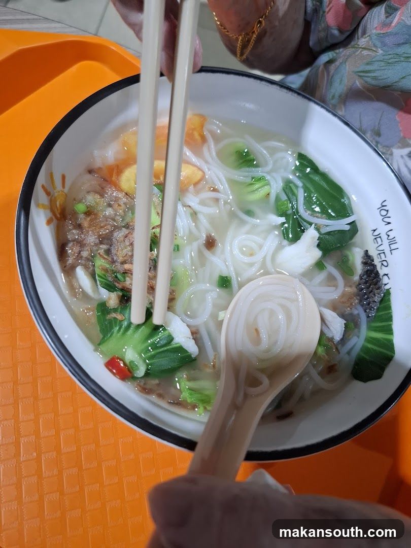 Bowl of Noodle Soup with Chopsticks and Spoon