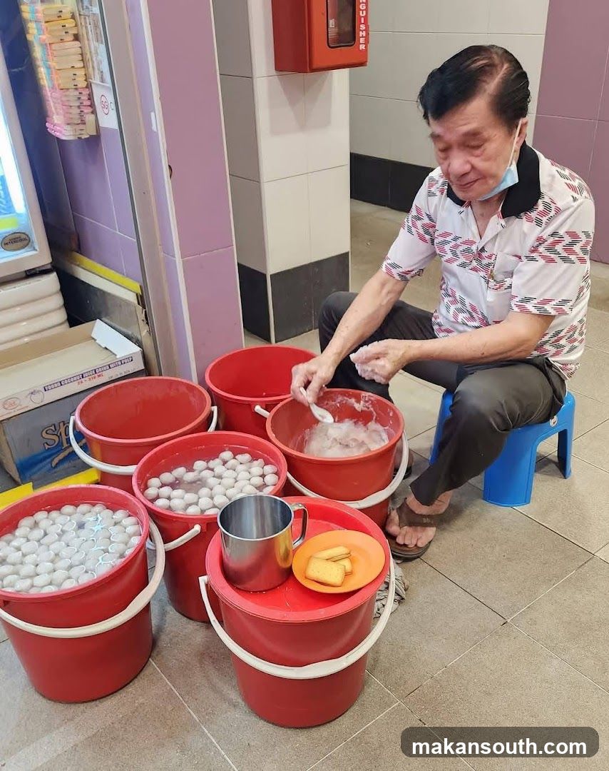 Man preparing food with buckets of ingredients