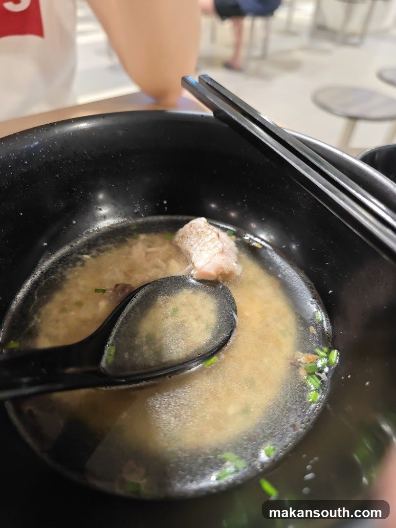 Bowl of Soup with Chopsticks and Spoon