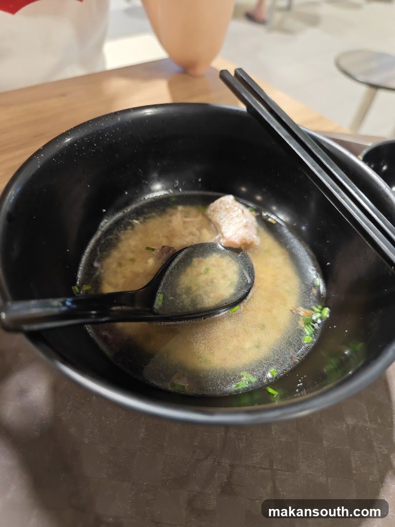 Bowl of Soup with Chopsticks and Spoon