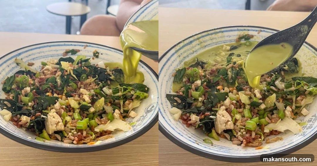 Bowl of rice with greens and tofu being drizzled with sauce