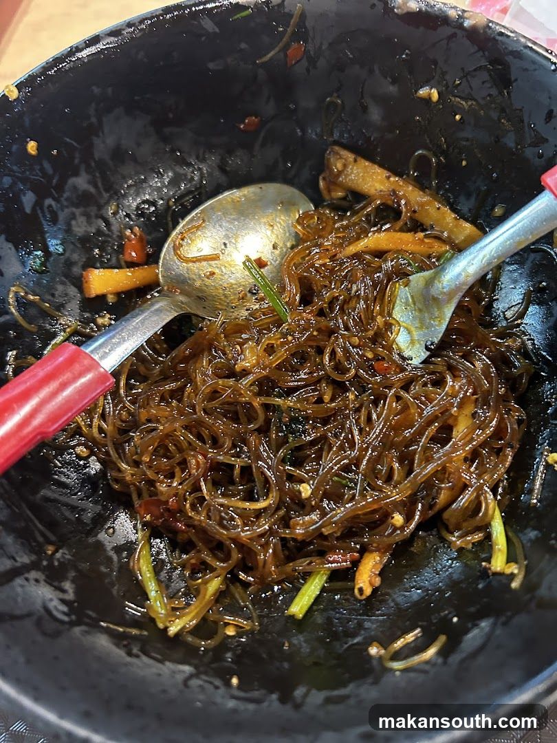 Stir-fried glass noodles in a wok