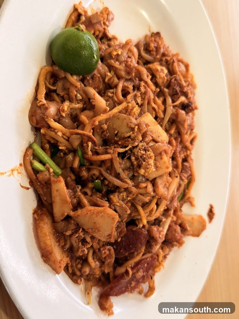 Stir-fried noodles with lime wedge