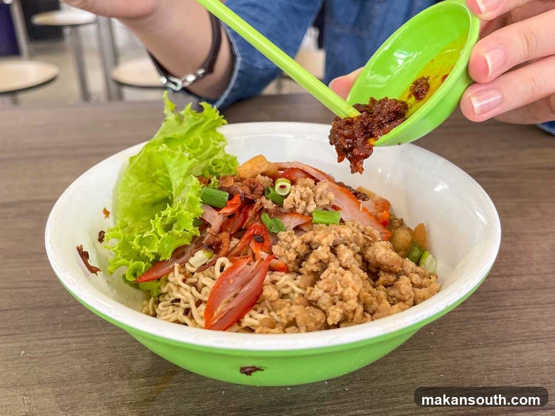 Noodle Bowl with Sauce Being Added