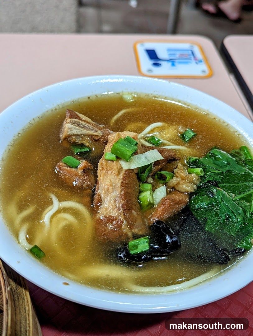 Bowl of Noodle Soup with Meat and Greens