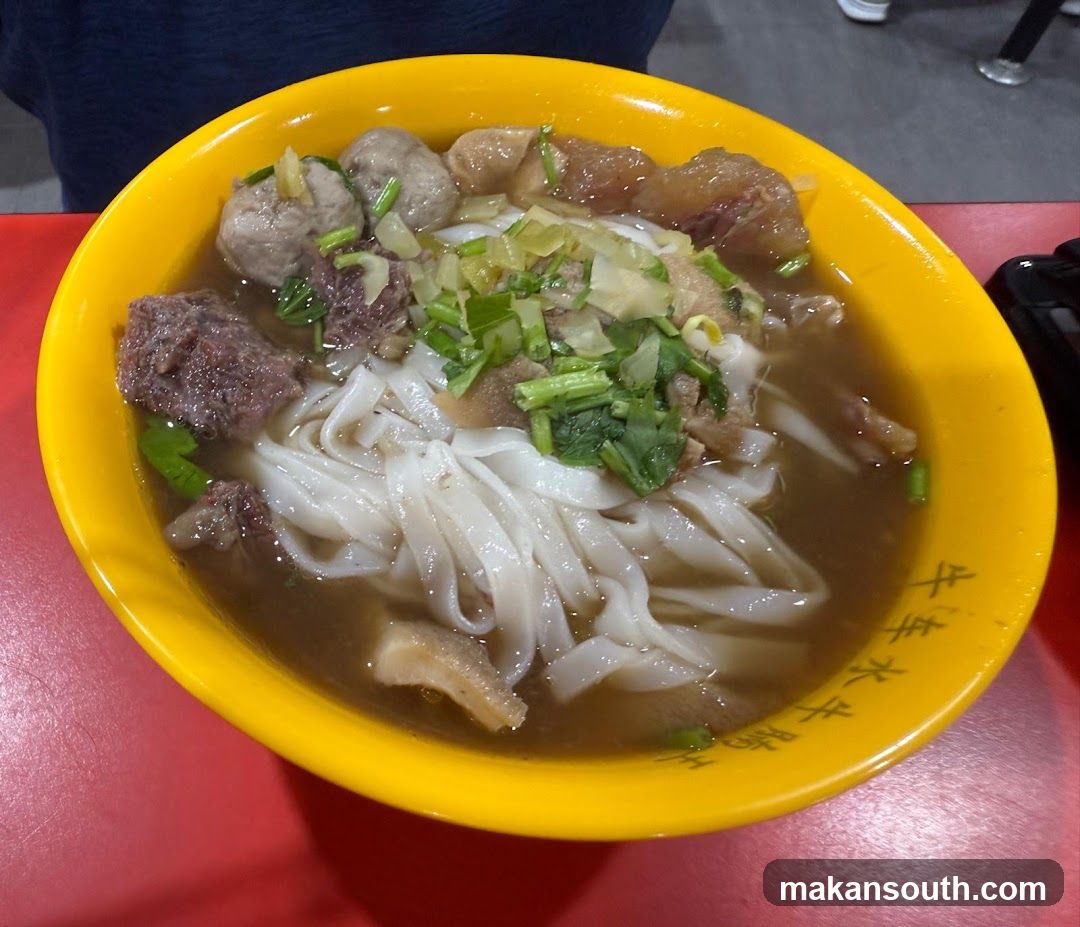 Bowl of Noodle Soup with Meat and Greens