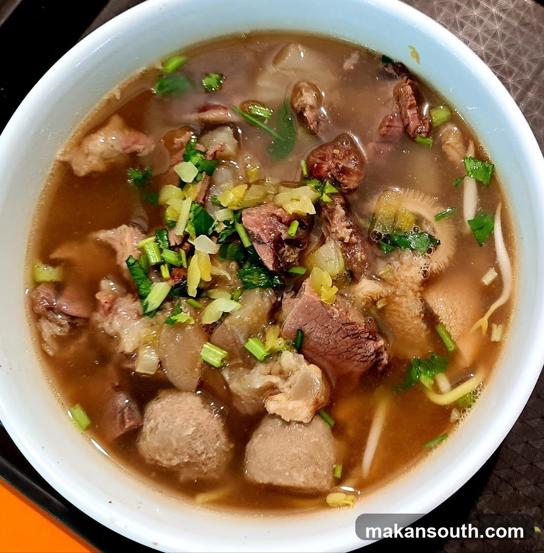 Bowl of Beef Soup with Meatballs and Greens