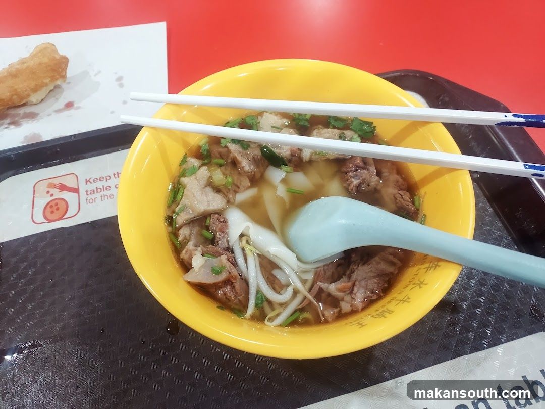 Bowl of Noodle Soup with Chopsticks and Spoon