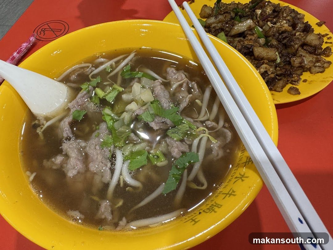 Bowl of beef noodle soup with side dish