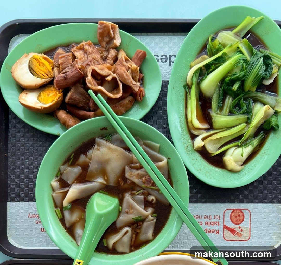 Cantonese-style food tray with noodles and side dishes