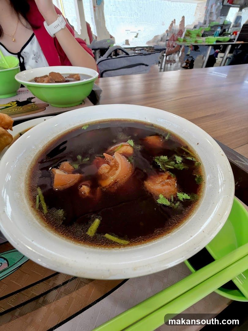 Bowl of Soup with Meat and Herbs