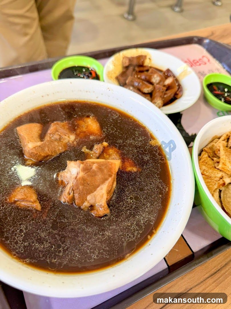 Bowl of Dark Broth with Meat and Side Dishes