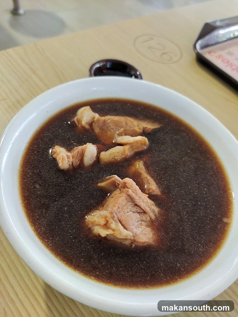 Bowl of Dark Broth with Meat