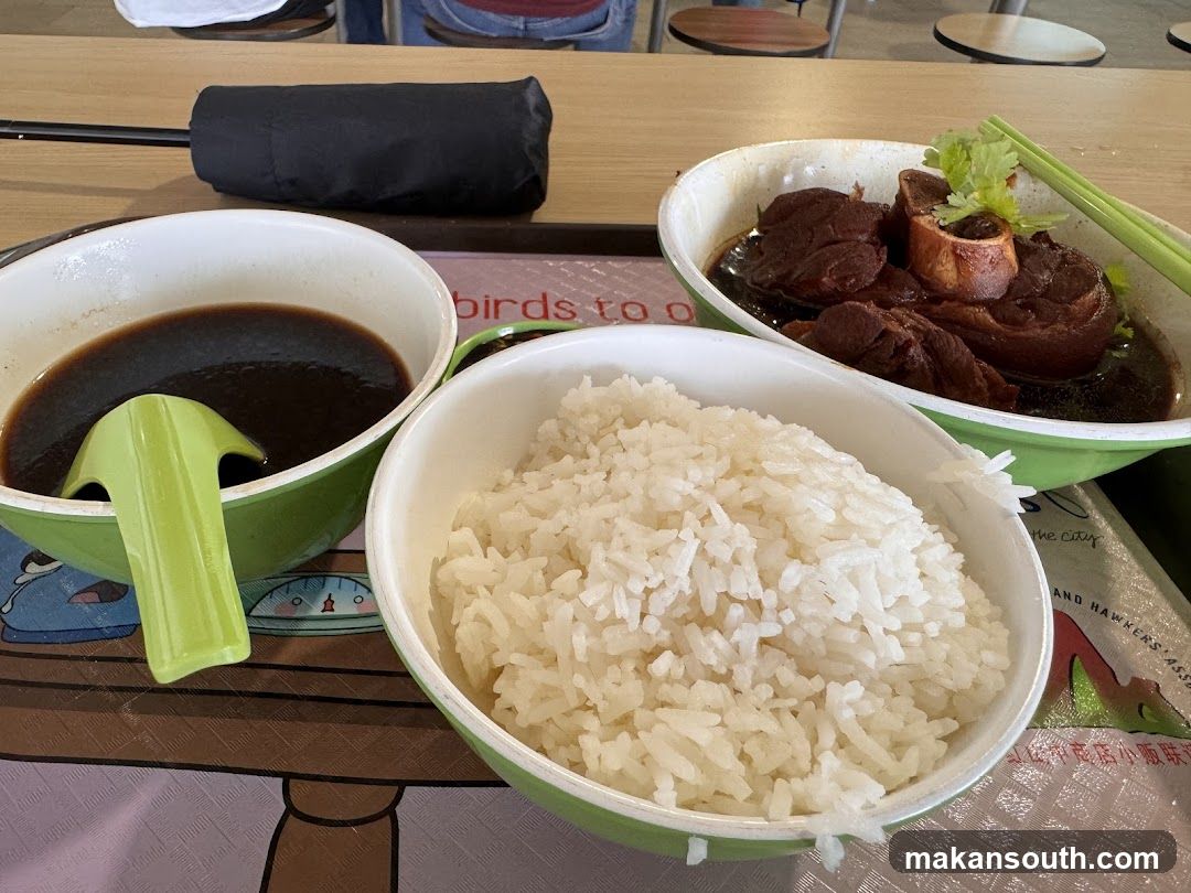 Bowl of food with rice and sauce
