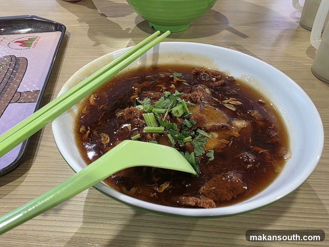 Bowl of Soup with Chopsticks and Spoon