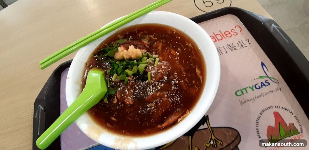 Bowl of Soup with Chopsticks and Spoon