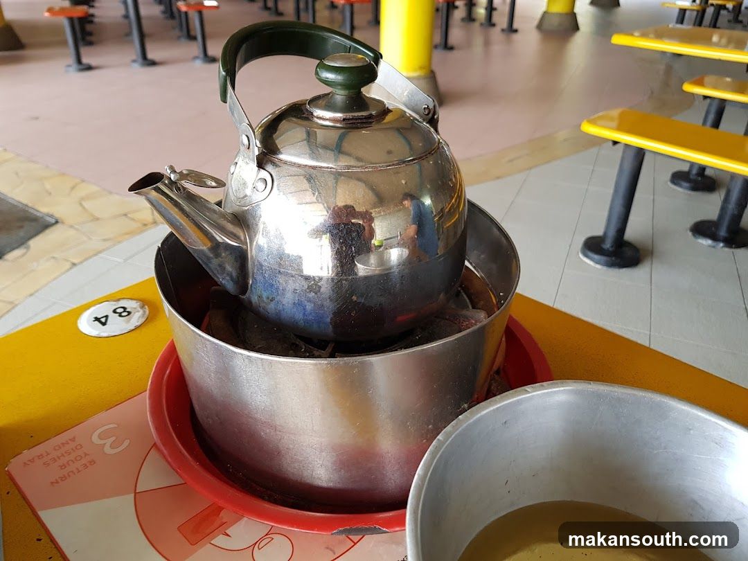 Kettle on Charcoal Burner at Food Court Table