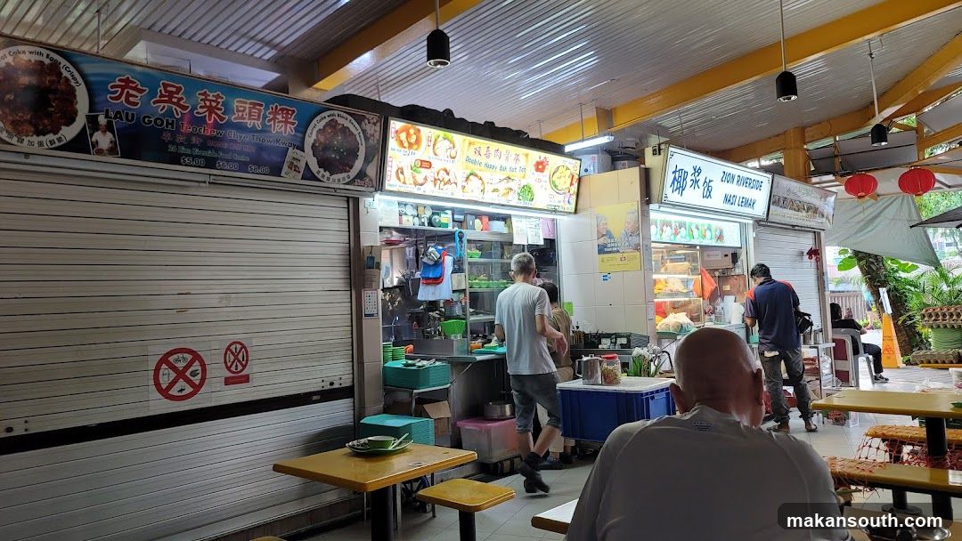 Food stall interior with customers and signage